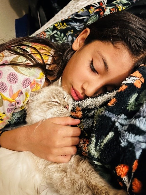 New owners daughter sleeping next to the kitten they adopted