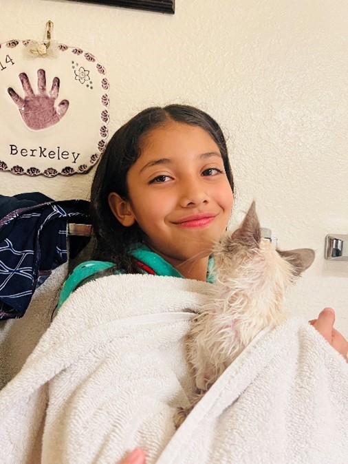 New owners daughter holding the kitten they adopted