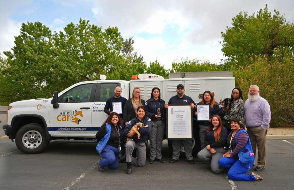 Animal Care team standing in front of a truck
