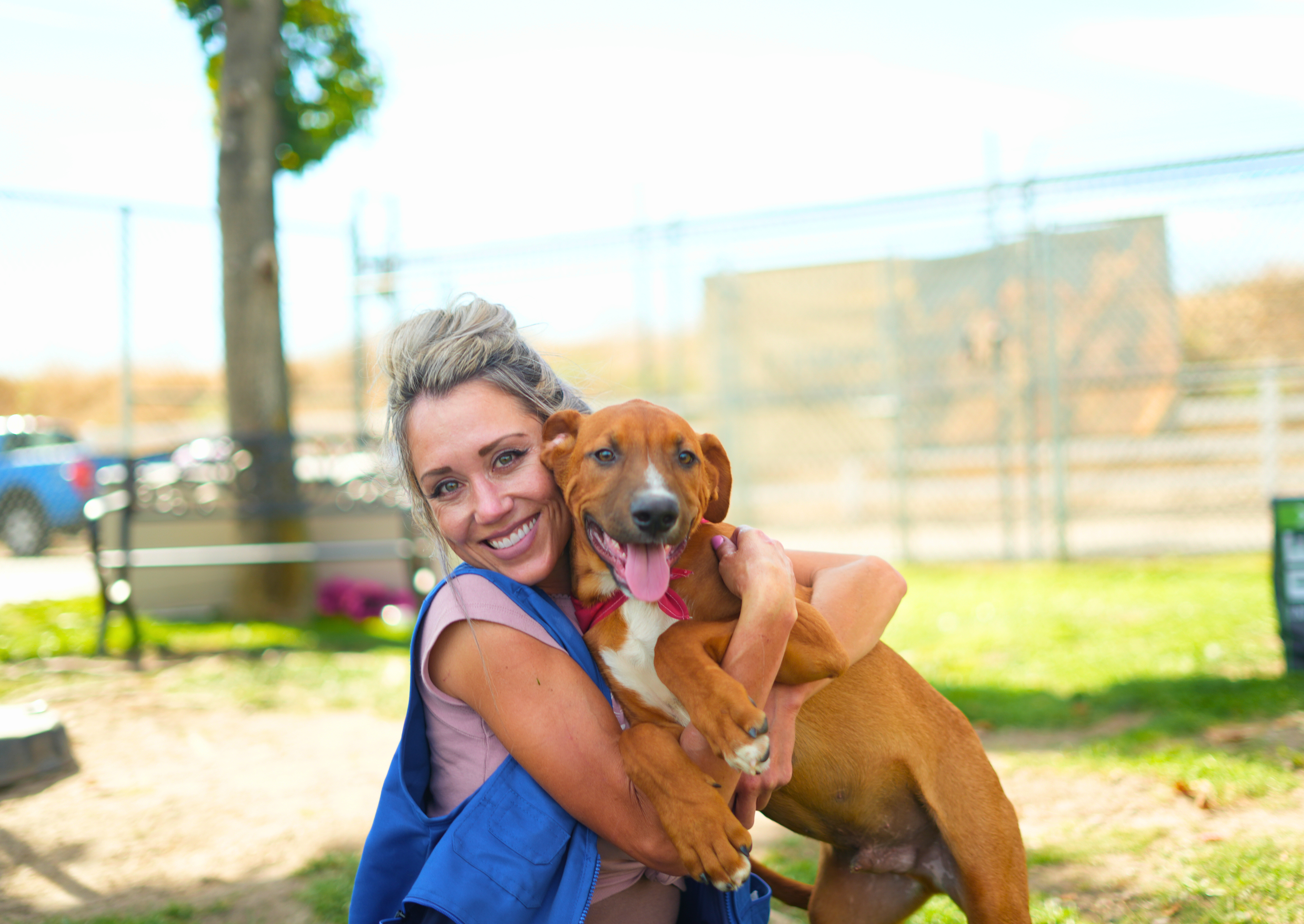 Enrichment Specialist hugging a puppy