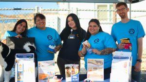 Volunteers at an event helping a health education specialist promote the programs and services
