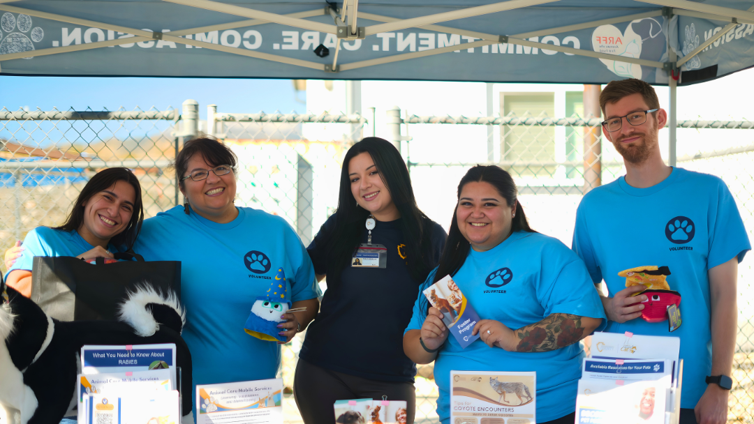 Volunteers smiling with a health education specialist